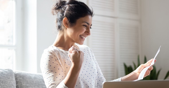 woman smiling looking a low summer air conditioning bill