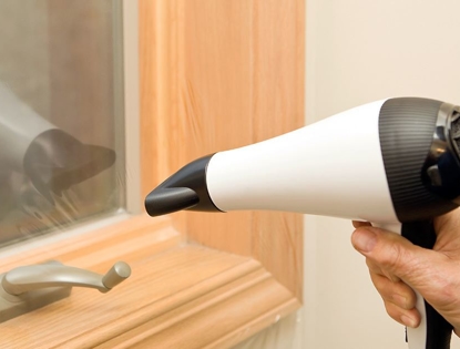 Hair Dryer blow drying a window